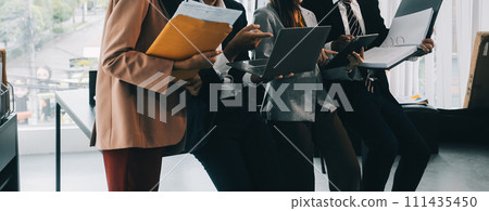 Co working conference, Business team meeting present, investor colleagues discussing new plan financial graph data on office table with laptop and digital tablet, Finance, accounting, investment. Co working conference, Business team meeting present, investor colleagues discussing new plan financial graph data on office table with laptop and digital tablet, Finance, accounting, investment. 111435450