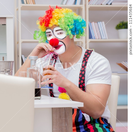 Drunk clown celebrating having a party at home 111435684