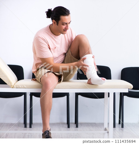 Young injured man waiting for his turn in hospital hall 111435694