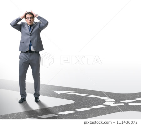 Young businessman at crossroads in uncertainty concept 111436072