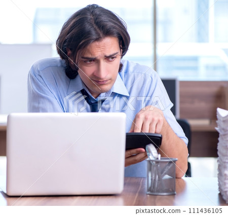 Young employee unhappy with excessive work 111436105