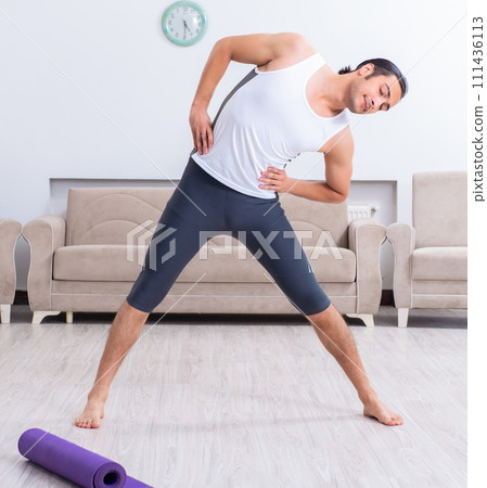 Young man training and exercising at home 111436113