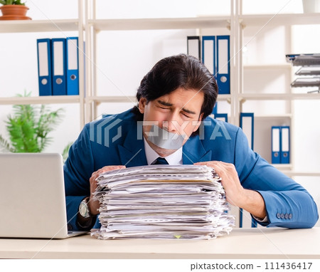 Young male employee with tape on the mouth Young male employee with tape on the mouth 111436417