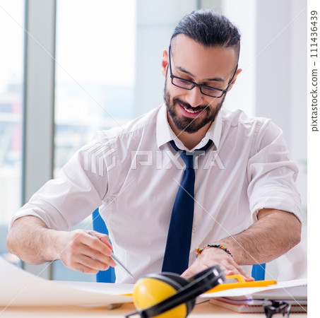Architect working in his studio on new project 111436439