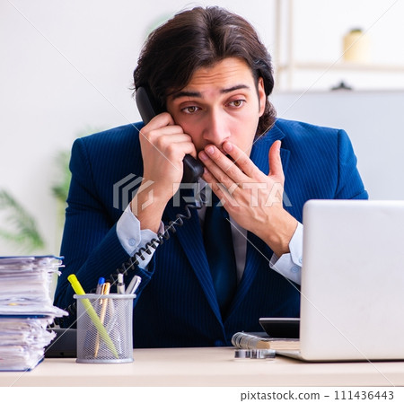 Young businessman sitting and working in the office 111436443
