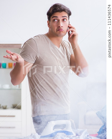 Inattentive husband burning clothing while ironing 111436574