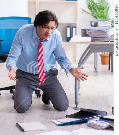 Young male employee unhappy with excessive work 111436956