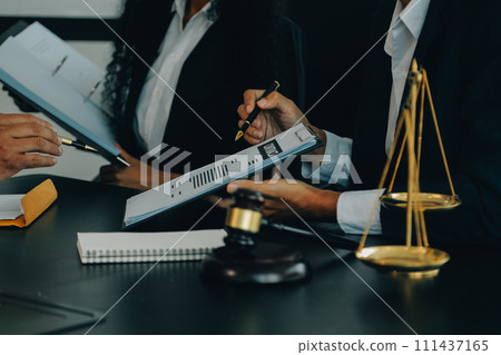 Judge gavel with Justice lawyers having team meeting at law firm background. Concepts of Law and Legal services. 111437165