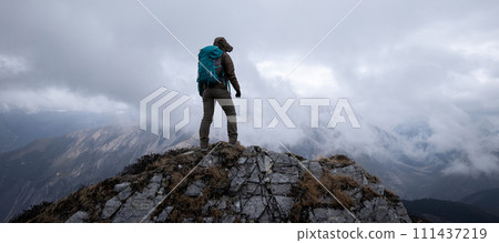 Woman hiker hiking at mountain top in tibet Woman hiker hiking at mountain top in tibet 111437219