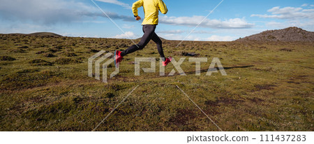 Woman trail runner cross country running to high altitude mountain peak 111437283