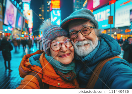 Elderly happy couple takes selfie on a neon-lit street, 111440486