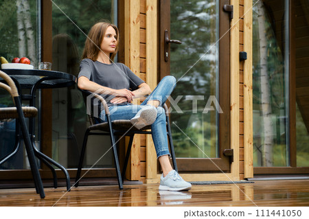A lovely woman is resting in silence in her country house 111441050