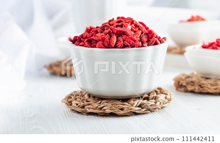 Dried goji berries on a white table. Dried goji berries on a white table. 111442411