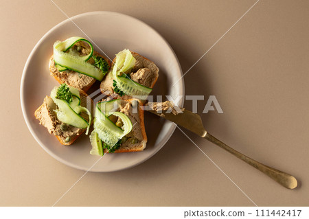 Toasts with pate on a beige background. 111442417