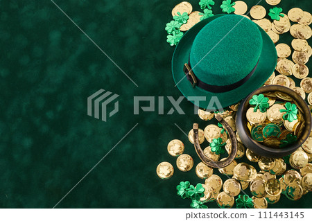 Happy St. Patrick's Day background with a leprechaun green hat full of gold coins Happy St. Patrick's Day background with a leprechaun green hat full of gold coins 111443145