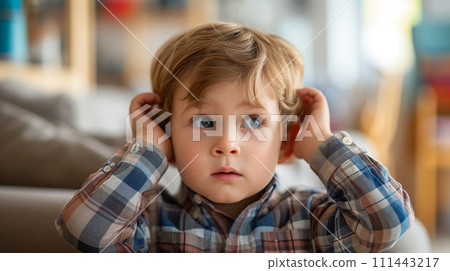 AI-generated content. Little autistic boy closing ears with his hands in a protective position. 111443217