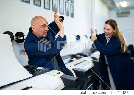 Engineer and office worker have fun in printing house 111443221