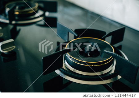 Luxurious black and gold stove top an opulent choice for high-end kitchens. Modern design clean appliance lavish addition to upscale house interiors give me..Elegant black and gold gas stove Luxurious black and gold stove top an opulent choice for high-end kitchens. Modern design clean appliance lavish addition to upscale house interiors give me..Elegant black and gold gas stove 111444417
