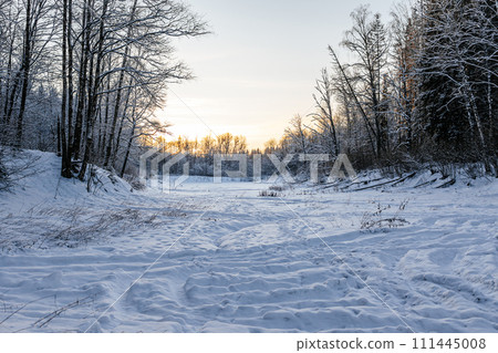 winter landscape on a pond. beautiful winter sunset. snowy nature landscape 111445008
