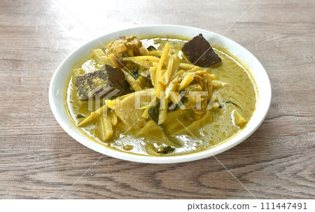 spicy boiled slice fresh bamboo shoot with chicken and blood in coconut milk curry soup on plate spicy boiled slice fresh bamboo shoot with chicken and blood in coconut milk curry soup on plate 111447491