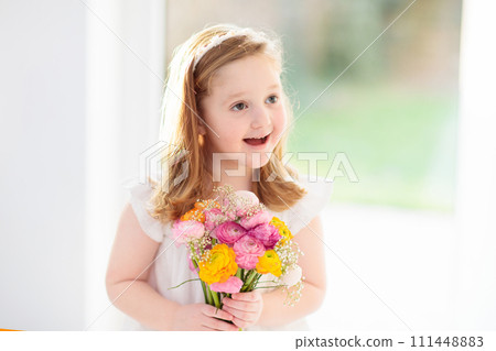 Little girl with flower bouquet 111448883