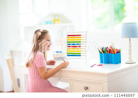Child drawing. Kids paint. Girl after school. 111448897