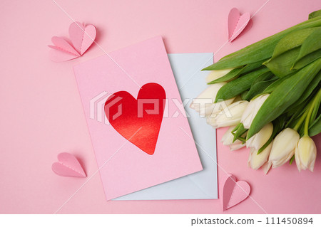 Handmade Valentine greeting card with white tulips on pink background with paper hearts. Valentine's Day letter 111450894