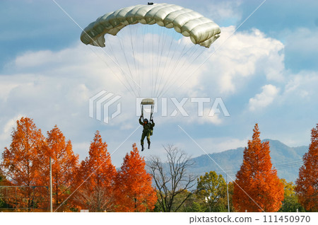 Ground Self-Defense Force paratroopers descend into the autumn leaves Ground Self-Defense Force paratroopers descend into the autumn leaves 111450970