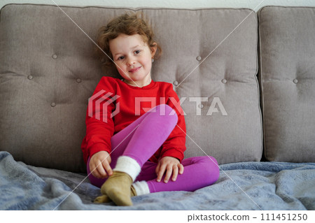 Funny little girl smiling, child looking at camera at home, happy childhood Funny little girl smiling, child looking at camera at home, happy childhood 111451250