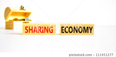 Sharing economy symbol. Concept words Sharing economy on beautiful wooden blocks. Beautiful white table white background. Wooden beautiful chest coins. Business sharing economy concept. Copy space. 111451277
