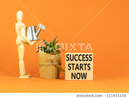 Success starts now symbol. Concept word Success starts now on beautiful wooden block. Businessman model. Beautiful orange table background. Business motivational success starts now concept. Copy space Success starts now symbol. Concept word Success starts now on beautiful wooden block. Businessman model. Beautiful orange table background. Business motivational success starts now concept. Copy space 111451338