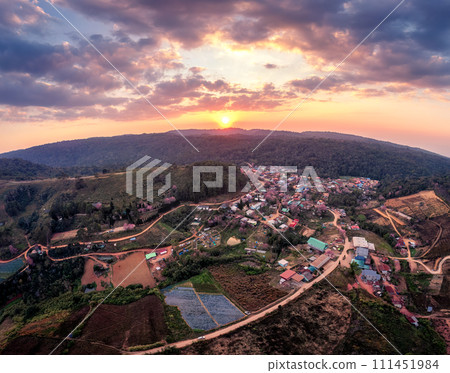 Sunset over Thai tribe village with wild himalayan cherry tree blooming in countryside at Ban Rong Kla Sunset over Thai tribe village with wild himalayan cherry tree blooming in countryside at Ban Rong Kla 111451984