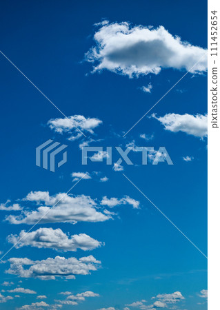 Bright day, fluffy clouds dotting the blue sky. 111452654