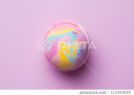 A single colorful bath bomb against purple background. Flat lay, top view 111453035