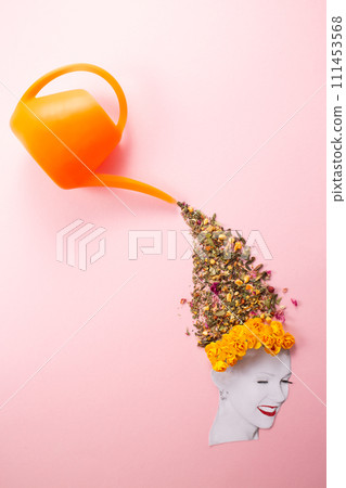 Hair is watering with herbs on pink background. Hairloss, treatment concept Hair is watering with herbs on pink background. Hairloss, treatment concept 111453568