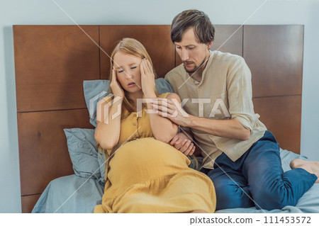 Expectant woman feels unwell, husband comforts and reassures her during a challenging pregnancy Expectant woman feels unwell, husband comforts and reassures her during a challenging pregnancy 111453572