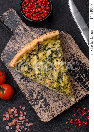 Delicious crispy quiche cut into slices with cheese, broccoli, tomatoes 111453990