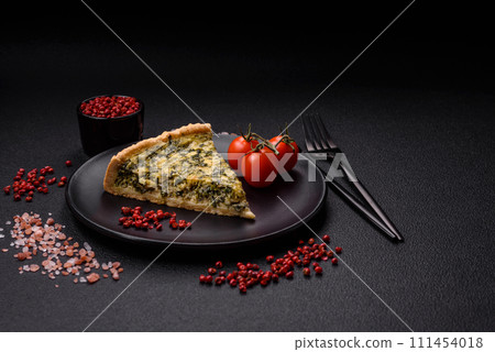 Delicious crispy quiche cut into slices with cheese, broccoli, tomatoes 111454018