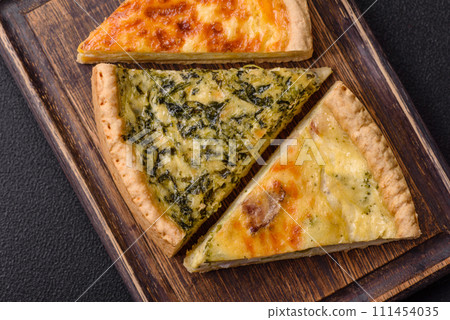 Delicious crispy quiche cut into slices with cheese, broccoli, tomatoes Delicious crispy quiche cut into slices with cheese, broccoli, tomatoes 111454035