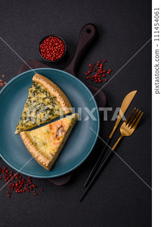 Delicious crispy quiche cut into slices with cheese, broccoli, tomatoes 111454061