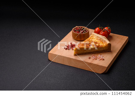 Delicious crispy quiche cut into slices with cheese, broccoli, tomatoes 111454062