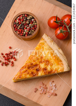 Delicious crispy quiche cut into slices with cheese, broccoli, tomatoes 111454067