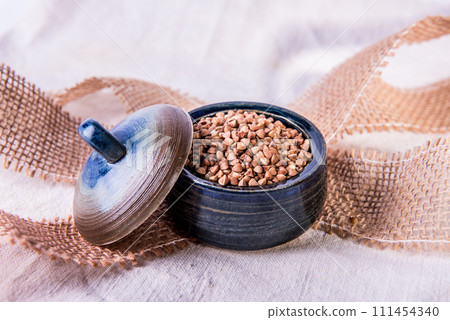 Bowl with raw uncooked buckwheat, Raw Buckwheat Pile, Dry Buck Wheat Grains, Uncooked Buckwheat 111454340