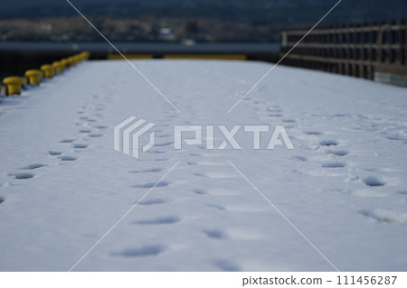 Footprints in the snow on the pier Footprints in the snow on the pier 111456287