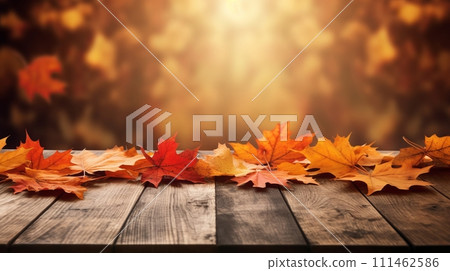 Rustic wooden table adorned with colorful autumn leaves 111462586