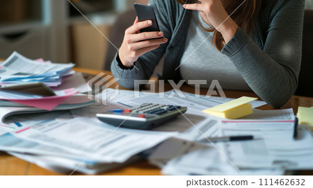 a stress woman managing taxes on the phone with a tax advisor 111462632