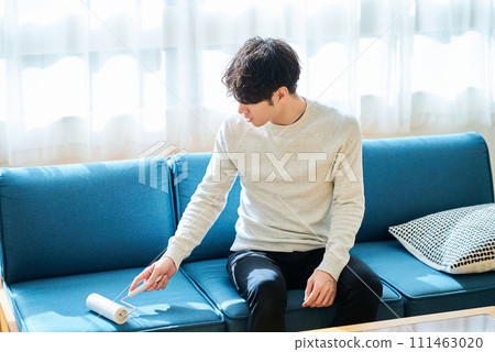 young man cleaning the sofa young man cleaning the sofa 111463020