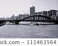 Monochrome urban landscape with river, old-fashioned bridge and boats 111463564