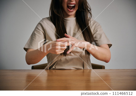 A woman in her 30s takes off her wedding ring because she can't control her anger. A woman in her 30s takes off her wedding ring because she can't control her anger. 111466512