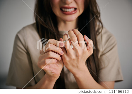 A woman in her 30s takes off her wedding ring because she can't control her anger. A woman in her 30s takes off her wedding ring because she can't control her anger. 111466513